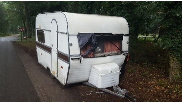 Caravan vol grofvuil gedumpt langs de openbare weg