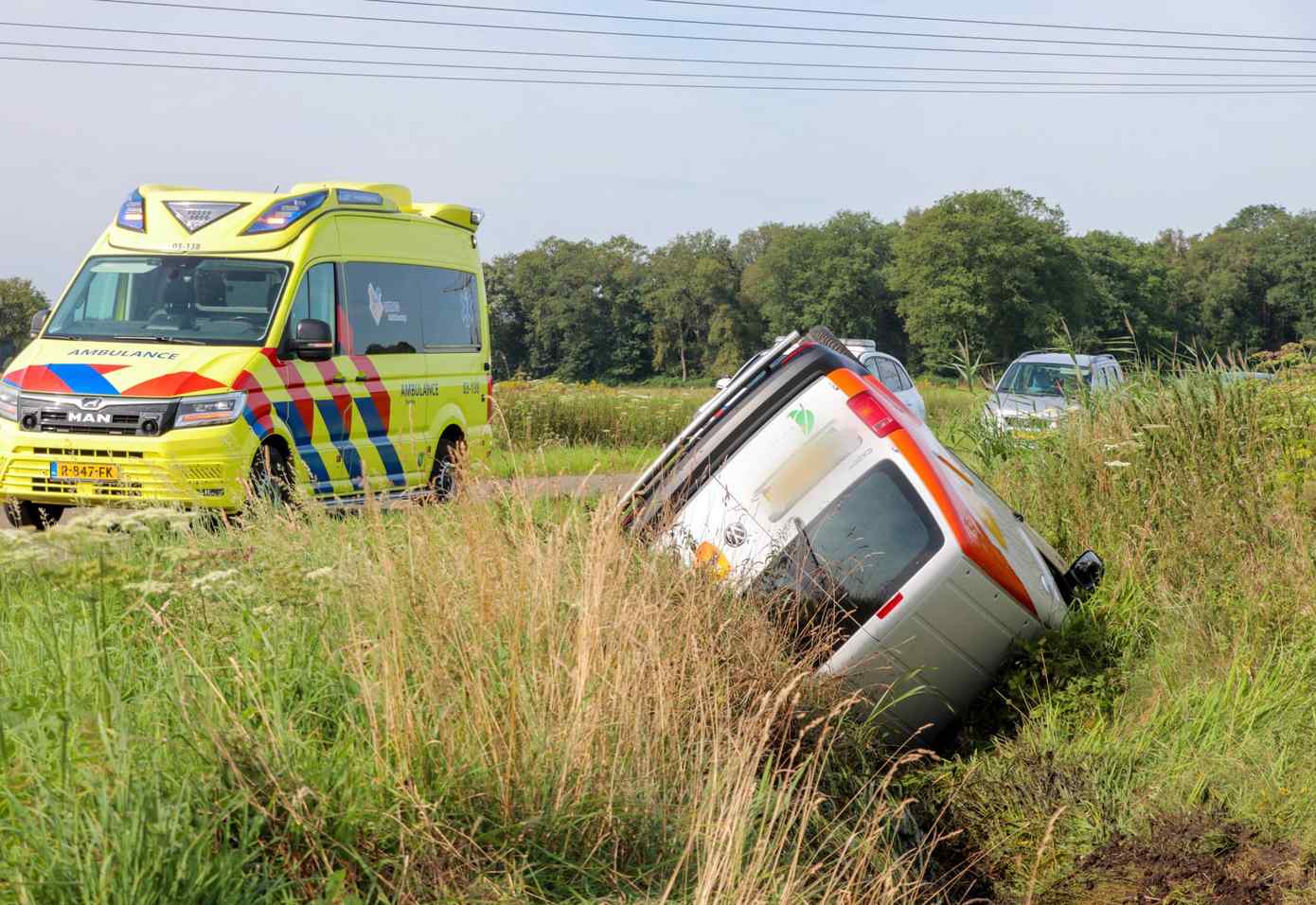 Pakketbezorger op de kop in de sloot na eenzijdig ongeval